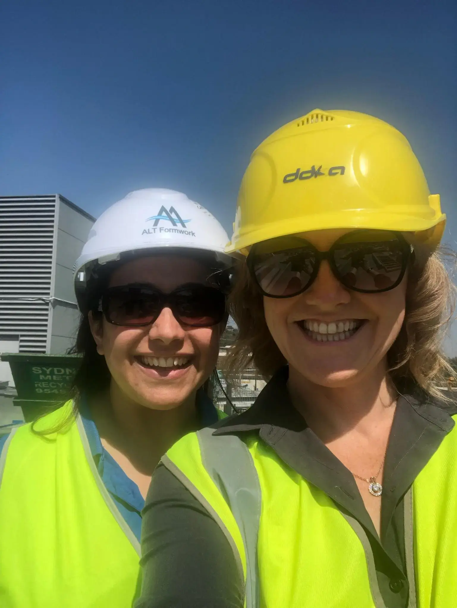 Antoinette laughing with her crew over coffee on a Brisbane build site